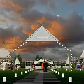 Scenic Glamping Campground With Tipi Tents String Lights Stone Path And Sunset Sky