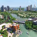 Aerial Urban Planning With Riverside Modern Residential Buildings Green Spaces Bridge And Boats