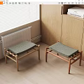 Two Wooden Frame Stools With Gray Padded Seats In Cozy Indoor Corner