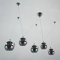 Multiple Silver Spherical Pendant Lights Hanging from White Ceiling in Modern Space 3d model