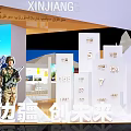 Xinjiang Themed Exhibition Booth Featuring Mountain Lake Views Traditional Architecture Human Figures And Digital Screens
