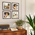 Wooden Frame With Photo On Wooden Cabinet Near Potted Plant And Radio Against Light Wall