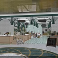 Shopping Mall Lobby Interior With Green Arch Structures Wooden Counters And Colorful Floor Tiles