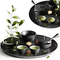 Elegant Black Tea Set with Teapot Teacups Trays Green Leaves Candles and Plant Vase