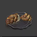 Two Fresh Braided Bread Loaves on Black Plate with Bitten Piece