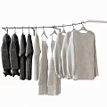 Soft Dark and Light Knitted Clothes Hanging on a White Clothes Rack