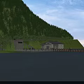 Beautiful Mountain Landscape Featuring Dense Forest Lakefront Buildings Green Grass And Blue Sky