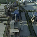 Aerial View Of Modern Industrial Factory Building With Large Structures Pipes Equipment And Roads