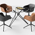 Modern Round Glass Top Table With Black And Brown Chairs And Metal Legs