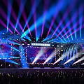 Colorful Concert Stage with Large LED Screen and Audience Waving Light Sticks