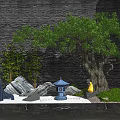 Courtyard Garden Design Featuring Large Tree Bamboo Rock Formations Blue Lantern And Water Reflections