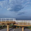 Elevated Spiral Walkway With White Railings And Wooden Supports In Open Grassland