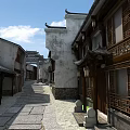 Traditional Commercial Street With Ancient Architecture White Walls And Wooden Carved Windows