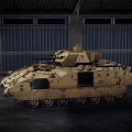 Two Sand Colored Military Tanks With Tracks Parked In Industrial Warehouse