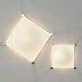Two Square Wall Lamps With White Round Shades Mounted On Light Gray Wall