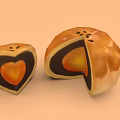 Heart Shaped And Round Mooncakes Cut Open With Orange Filling And Golden Crust