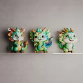Three Cute Cartoon Dragon Sculptures With Vibrant Colors And Green Design On Shelf