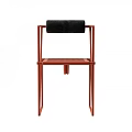 Modern Single Chair Featuring Red Metal Frame And Black Cushioned Backrest Design