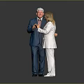 Two People In Formal Wear Blue Suit White Outfit Interacting With Items On Gray Background