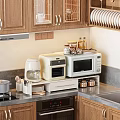 Modern Kitchen Appliances Including Toaster Oven Microwave On Organized Counter With Wooden Cabinets