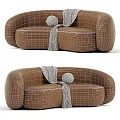 Curved Beige And Brown Sofa With Gray Throw Blanket And Round Pillow