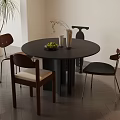 Round Black Table And Chairs Set With Fruits Vase And Indoor Plant On Wooden Floor