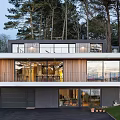 Contemporary Detached Villa with Expansive Glass Windows Horizontal Wooden Cladding and Tree Surrounded Garden