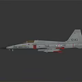 Gray Fighter Jet With Blue Nose Weapon Attachments And Tail Fin Logo