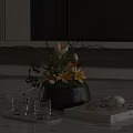 Black Vase With Yellow Flowers Green Foliage And Dark Berries On Marble Countertop