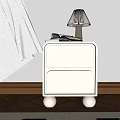 White Bedside Table With Two Drawers Round Legs Lamp Books On Wooden Floor Sunlight Shadows