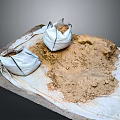 White Bags Filled With Sand Placed On White Cloth With Scattered Sand