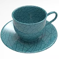 Teal Ceramic Teacup And Saucer With Intricate Cracked Pattern Design 3d model