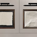 Textured Abstract Paintings in Dark Wooden Frames on Light Gray Wall with Black Light Fixtures