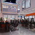 Modern Internet Cafe Reception Area With Sleek Flooring Bright Lighting And Snack Shelves