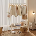 Cozy Bedroom Clothing Rack With Hanging Sweaters Storage Boxes And Teddy Bear