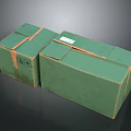 Two Green Cardboard Boxes With Tape Sealed And Label On Surface