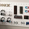 Headphones and Speakers on Wall Mounted Display with Controllers and Keyboard 3d model