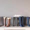 Various Colored Stylish High Heeled Boots Neatly Arranged On White Shelf