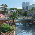 Vibrant Commercial Street With River Pedestrian Bridge Palm Trees Pedestrians Modern Buildings And Lush Greenery