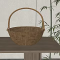 Stylish Natural Wicker Basket as Household Item on Wooden Table with Bamboo Plant