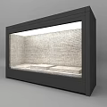 Black Display Cabinet with Glass Door Top Lighting Internal White Platforms and Brick Wall Background