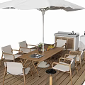 Stylish Outdoor Table Setup On Wooden Deck With White Umbrella Chairs And Kitchen Unit