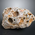 Natural Porous Stone with Irregular Holes and Gray Orange Surface Texture