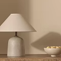 Modern Table Lamp With Concrete Base Linen Shade On Wooden Table With Fruit Bowl