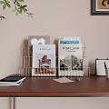 Books And Magazines Organized In Wire Rack On Wooden Desk With Calendar Pens And Papers