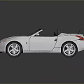 White Modern Convertible Sports Car With Black Soft Top Two Seats And Silver Wheels