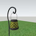 Outdoor Lantern With Yellow Diamond Pattern And Black Curved Metal Stand On Green Grass