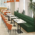Modern Restaurant Interior With Orange Beige Chairs Marble Tabletops And Green Booth Seats