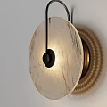 Modern Round Marble Disc Wall Sconce With Black Metal Frame And Warm Illuminated Light
