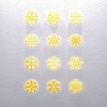 Golden Snowflake Sculptures With Various Intricate Designs On White Textured Background